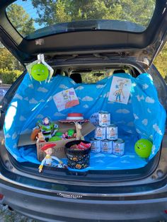 the trunk of a car is filled with toys