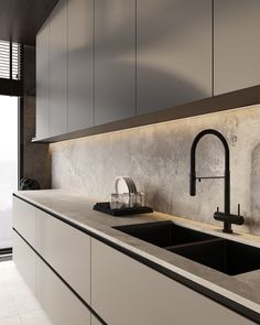 a modern kitchen with white cabinets and black faucets on the countertop, along with a large window