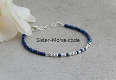 "This sister bracelet Morse code is the perfect gift idea for a sisters gift!  This Morse code bracelet is made with glass seed beads that are different shades of blue and purple, and sterling silver round beads and tube beads for the dots and dashes.  I've also added a small crystal to each side for a little sparkle. This makes a perfect gift for sister from sister! Details: ~Bracelet measures 7\" with a 1\" extension ~Made of sterling silver tube beads ~Finished with a lobster clasp ~A silver Bracelet Morse Code, Bracelet Morse, Code Morse, Wheeling Wv, Faith Bracelet, Sister Bracelet, Faith Jewelry, Morse Code Bracelet, Gift For Sister