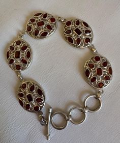 This bracelet has 5 filigree sterling silver ovals; each oval has a central cabochon, with 8 more cabs around it. The bracelet is very fluid in movement; it sits gently on the wrist following the contours. The length total is just over 8.5". The options are closure at 7.5", 8", and 8.5". Luxury Silver Bracelets With Cabochon, Silver Oval Bracelets With Intricate Design, Silver Oval Cabochon Bracelet, Elegant Silver Cabochon Bracelets, Elegant Sterling Silver Bracelet With Cabochon, Elegant Sterling Silver Cabochon Bracelet, Sterling Bracelets, Bling Bling, Dream Wardrobe