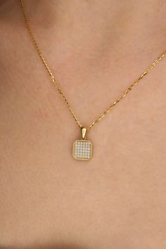 Sparkle with sophistication in this elegant Trendy Cornered Square Pendant Necklace. Crafted in luxurious 14k gold, this pendant features a dazzling zircon stone that captures the essence of timeless beauty. The unique cornered square design adds a modern touch to this classic piece, making it a versatile accessory for any occasion. Whether you're dressing up for a special event or elevating your everyday look, this necklace exudes charm and style. Elevate your jewelry collection with this exqui Tarnish Resistant Cubic Zirconia Diamond Pendant Necklace, Tarnish Resistant Cubic Zirconia Pendant Necklace, Elegant Gold Diamond Necklace With Pave Setting, Luxury Gold-plated Necklaces With Pave Setting, Luxury Gold-plated Necklace With Pave Setting, Timeless Gold Necklace With Pave Setting, Dazzling 14k Gold Diamond Necklace With Pavé Setting, Elegant Diamond Necklace With Rectangular Pendant, Dazzling 14k Gold Pave Setting Necklaces