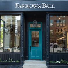 the entrance to farrow & ball is blue and has windows with flowers in them