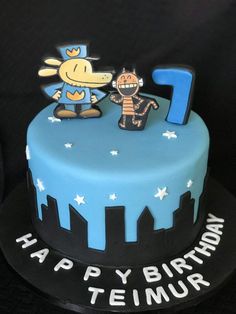 a blue and black birthday cake with the number one on it