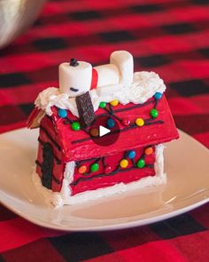 a red and white cake with marshmallows on it sitting on a plate