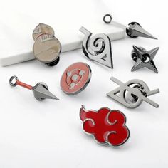 several different types of pins and magnets on a white surface