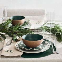 a place setting with green dishes and silverware