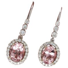 These beautiful drop earrings features two 2.52 cttw morganite oval gemstones with natural earth mined diamonds all set in solid 14k gold. A stunning pair of drop earrings which also make a beautiful June birthstone gift for your loved ones.  Specifications Item Type: Earring Center Stone: Morganite Treatment: Heated Weight: 2/2.52 cttw Head size: 8x6mm Shape: Oval Hardness: 7.5-8 Metal: 14k/3.292g Diamond Clarity/Color: SI / G-H Diamond Count/Weight: 46/0.59 cttw SKU: AJE160/3642 These earrings are made with solid 14k Gold and natural earth mined SI / G-H Diamonds. As listed, these earrings are ready to ship. If you're interested in purchasing this setting with a different center stone please message us! June Birthstone, Natural Earth, June Birth Stone, Diamond Clarity, Morganite, Gemstone Jewelry, Jewelry Earrings, Drop Earrings, Gemstones