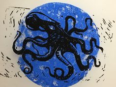 an octopus drawn in black on a blue circle