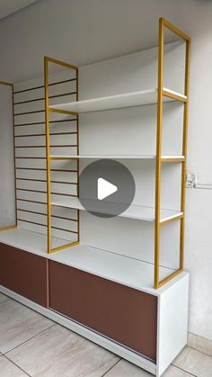 an empty room with shelves and shelving unit in it's display area, which is painted brown and white