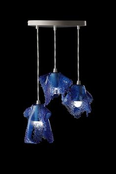 three blue glass lights hanging from a ceiling