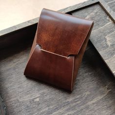 a brown leather case sitting on top of a wooden table