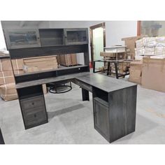 an office desk with drawers and shelves in a warehouse