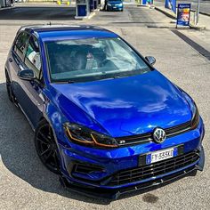 a blue car is parked on the street