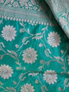 **SILK MARK CERTIFIED** **Gorgeous pure Banarasi Katan Roopa Sona Silk Saree with blouse piece (unstitched) in Turquoise And Silver** **100% silk and high quality** **Direct from Banaras** Material: 100% Katan Roopa Sona Silk Blouse piece: Included (Unstitched) Fall and Pico: YES Color: Turquoise And Silver Occasion: Festivals, Weddings, Cultural Events, Puja, Parties, Formal Gatherings, Family Functions, Graduations Experience the charm of this Handwoven Pink Banarasi Meenakari Katan Silk Saree, a beautiful blend of art and tradition. The deep pink color is the perfect backdrop for the detailed zari-woven Meenakari Jaal, a classic design that radiates elegance. The soft, luxurious silk falls gracefully, showcasing timeless beauty. Ideal for special occasions, this saree is a true showcase Luxury Katan Silk Saree With Resham Embroidery, Festive Turquoise Blouse Piece With Dupatta, Traditional Turquoise Blouse Piece For Festive Occasions, Turquoise Blouse Piece With Dupatta For Diwali, Turquoise Blouse Piece With Cutdana For Festive Occasion, Festive Turquoise Cutdana Blouse Piece, Festive Turquoise Dupatta With Zari Work, Turquoise Blouse Piece For Wedding And Festivals, Turquoise Saree With Resham Embroidery For Diwali