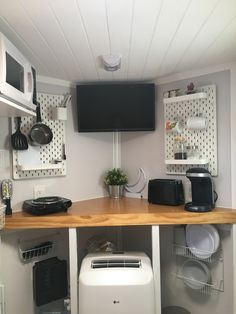 a kitchen area with microwave, toaster and dishwasher on the counter top