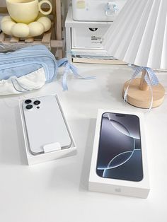 an iphone box sitting on top of a table next to a lamp and other items