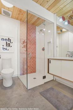 a bathroom with a toilet, sink and shower in it's center area is shown