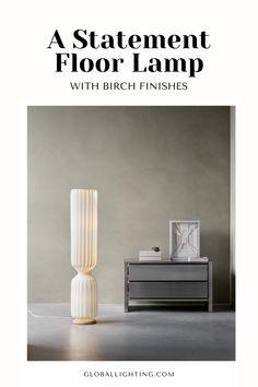 a white lamp sitting on top of a table next to a dresser and nightstand with the words, a statement floor lamp with birch finishes