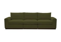 a green couch sitting on top of a white floor