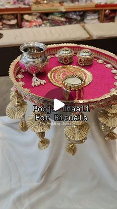 a pink tray with gold decorations on it