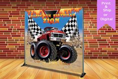 a red monster truck with checkered flags on it's sides is displayed in front of a brick wall