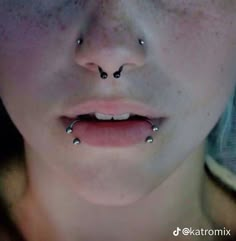 a woman with piercings on her nose is looking at the camera