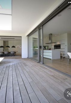 an outdoor deck with sliding glass doors leading to the kitchen and dining room area is seen in this image