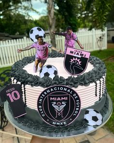 the cake is decorated with two soccer players