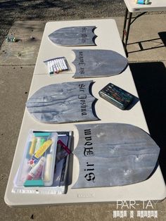 the table is set up with markers, pens, and other things to paint on