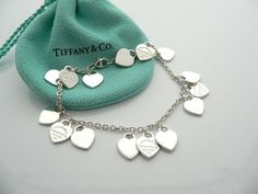 Overview:Offered for sale is a wonderful and gorgeous and rare Return to Tiffany & Co. Multi Hearts Dangle Charm bracelet.  Definitely a Tiffany piece that you will get your money's value for.  It works perfectly with pretty much any attire your put on, AND is an awesome statement piece.   Very pretty and unique piece!  It is the perfect bracelet that fits a lifestyle on the go -- the piece can be worn to pretty much any occasion!  It is simple, elegant, and classic all rolled into one neckl Tiffany Bracelet Stack, Tiffany Charm Bracelet, Luxury Wishlist, Tiffany Bracelet, Tiffany And Co Bracelet, Tiffany And Co Jewelry, Dangle Bracelet, Tiffany Bracelets, Return To Tiffany