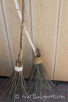 two brooms sitting next to each other on the ground