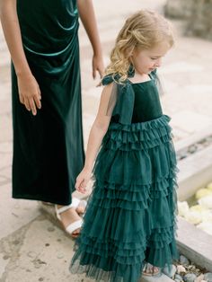 Let your little one twirl away in our Tallulah Velvet + Tulle dress. This Tallulah features a velvet top with a square neckline, one layer of tulle straps that self-tie into bows, and is finished with a tiered ruffle tulle skirt. Match it with the Frankie Velvet + Tulle dress for a mini-me moment! Model Demi; Size: 4T / Length: Regular, Age: 5, Height: 3'5 Model Marleese; Size: 4T / Length: Regular, Age: 5, Height: 3'8 FEATURES: Flowy A-line silhouette Velvet square neckline Self-tie tulle spagh Flower Girl Velvet Dress, Velvet Junior Bridesmaid Dress, Velvet Tulle Dress, Two Kids With Velvet Dress, Ruffle Tulle Skirt, Girls Red Velvet Dress, Girls Velvet Dress, Tulle Straps, Wedding Parties Colors