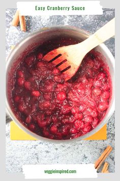 cranberry sauce in a pot with a wooden spoon