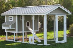 a chicken house with a slide in the yard