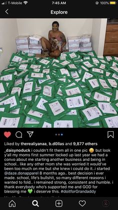 a man sitting on top of a bed covered in lots of green paper notes and papers