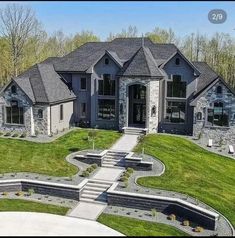 this is an aerial view of a house in the country side with stone and grass