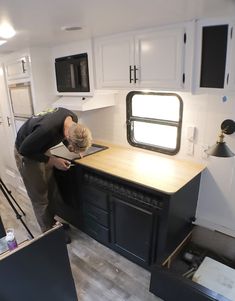 a man standing in front of a kitchen counter