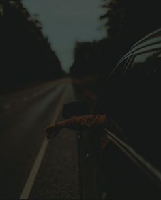 a car parked on the side of the road at night