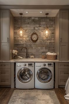 a washer and dryer in a room with wood flooring on the walls