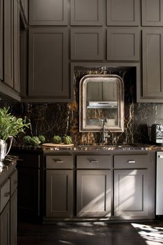 a kitchen filled with lots of brown cabinets and counter top space next to a sink