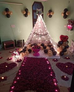 a teepee tent decorated with balloons and lights