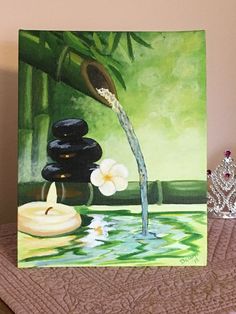 a painting of flowers and rocks on a table next to a water fountain with candles