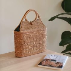 The Bali Tall Malboro Rattan Straw Handbag is the perfect accessory for any stylish woman. This beautiful, handmade rattan bag is made by skilled artisans in Bali, using natural materials to create a one-of-a-kind piece that is both fashionable and functional. The tall, cylindrical shape adds a unique touch to the classic rattan style, making it the perfect bag for everyday use or a night out. With its spacious interior and beautiful design, the Tall Malboro Rattan Handbag is sure to impress. Sh Rattan Style, Rattan Handbags, Well Woven, Straw Handbags, Rattan Bag, Coconut Shell, Buy Handmade, Perfect Bag, Traditional Techniques