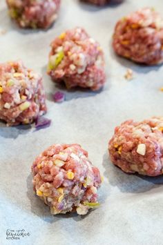 several balls of food sitting on top of a baking sheet