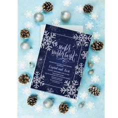 a blue and white snowflaked wedding suite with silver pineconis on a blue background