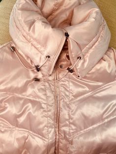 Hop on Barbie's Snowmobile with this  Shimmering Pink Barbie Parka by Nine West  This jacket is as multi-faceted as Barbie herself!  Work the apres-ski look with a multi-look neckline: Off-to-the-side, slouch chic,  Cuddly cute, open, Cozy, fireside snap-in-place, cowl-neck Chill-busting fully-zipped, drawstring high-neck   Down-filled  Cute Zip Pockets Cinched waistline adjustable drawstring  Curve-accenting adjustable belt Size: Medium  Sleeve: 23 inches  Note: Primary photo true to color Adjustable Belt, Pink Satin, Belt Size, To Color, Nine West, Parka, Zip Pockets, High Neck, Bathing Beauties