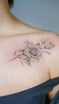 a woman with a rose tattoo on her shoulder