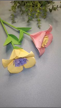 origami flowers and leaves on a table