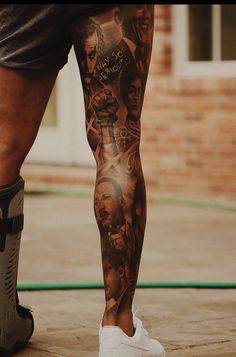 a man's leg with tattoos on it