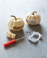 pumpkins with teeth and dental instruments on a table next to each other, including a toothbrush